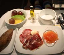 An afternoon snack of Iberico ham, fresh fruit, tomato and fresh bread given to Business Plus passengers on Iberia Airlines // © 2011 Mindy Poder
